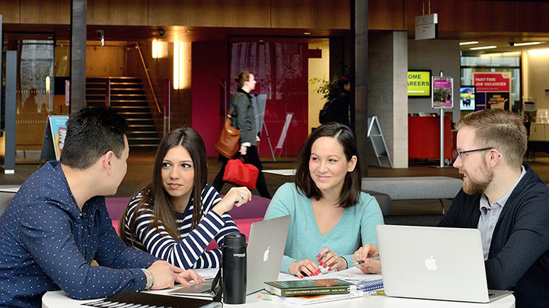 Students discussing work on campus